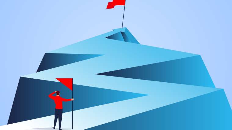Businessman holding a flag looking at the flag farther from the top of the arrow