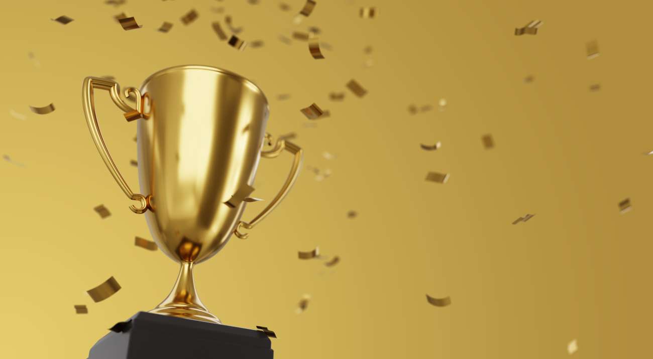 Golden winner cup and confetti