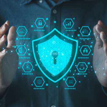 Businessman holding cyber security icons screen. Digital information technology and cyber security concept.