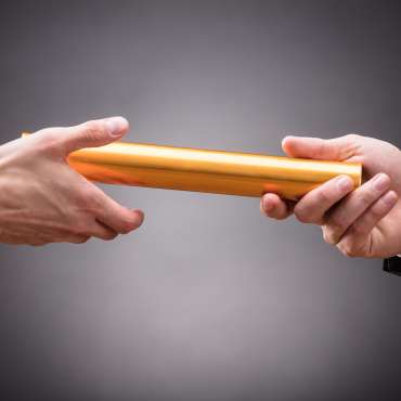 Person Passing Baton To Businessperson